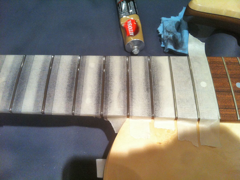 rubbing the fret with metal polish